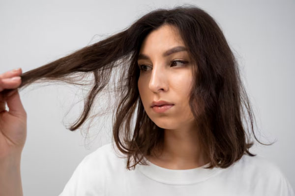 La calvicie y el pelo graso - Joven de cabello corto y descuidado se detiene a apreciar un mechón de pelo