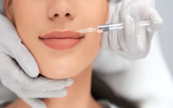 Revitalización facial con ácido hialurónico - Médico estético realizando un tratamiento con ácido hialurónico Madrid a una mujer en una de las mejores clínicas estéticas Madrid